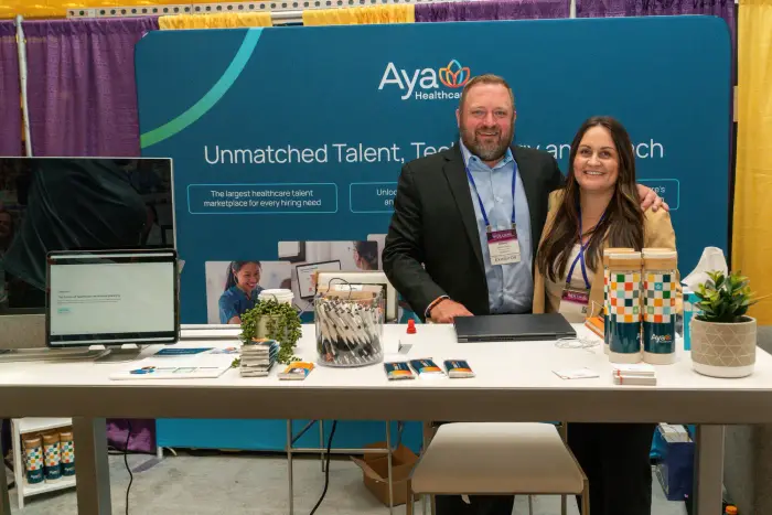 Two people at an exhibitor booth in the vendor hall